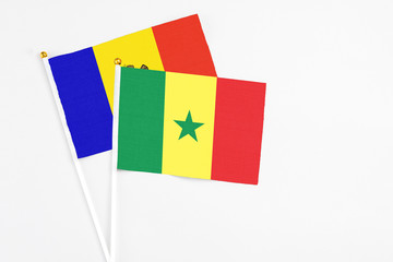 Senegal and Moldova stick flags on white background. High quality fabric, miniature national flag. Peaceful global concept.White floor for copy space.