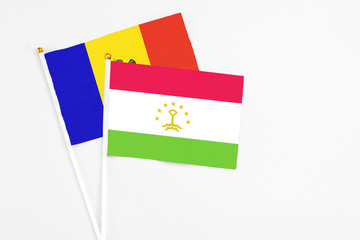 Tajikistan and Moldova stick flags on white background. High quality fabric, miniature national flag. Peaceful global concept.White floor for copy space.
