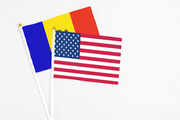 United States and Moldova stick flags on white background. High quality fabric, miniature national flag. Peaceful global concept.White floor for copy space.