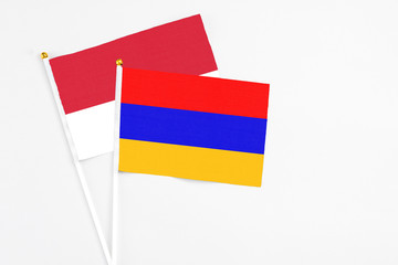 Armenia and Monaco stick flags on white background. High quality fabric, miniature national flag. Peaceful global concept.White floor for copy space.