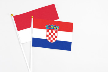 Croatia and Monaco stick flags on white background. High quality fabric, miniature national flag....