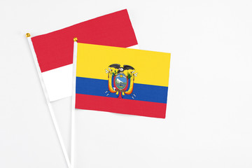 Obraz premium Ecuador and Monaco stick flags on white background. High quality fabric, miniature national flag. Peaceful global concept.White floor for copy space.