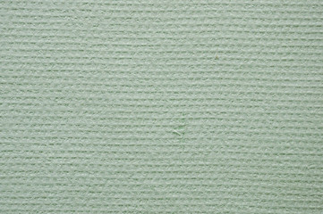 Embossed abstract pattern on a light green paper