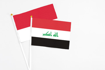 Iraq and Monaco stick flags on white background. High quality fabric, miniature national flag. Peaceful global concept.White floor for copy space.