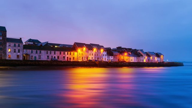 Galway, Ireland. Beautiful landscape of Galway, Ireland. River and famous painted houses with cloudy colorful sky. Time-lapse during the sunrise