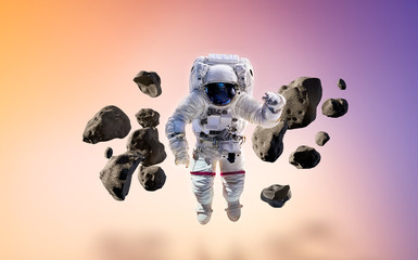 Astronaut on gradient isolated background with stones and asteroids. Glow from behind. Elements of...