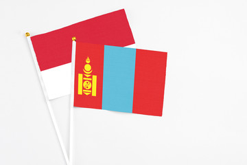 Mongolia and Monaco stick flags on white background. High quality fabric, miniature national flag. Peaceful global concept.White floor for copy space.