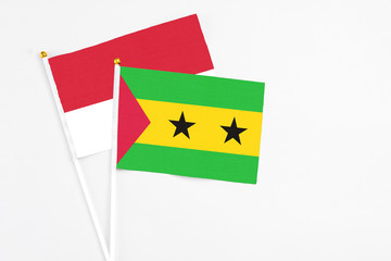 Sao Tome And Principe and Monaco stick flags on white background. High quality fabric, miniature national flag. Peaceful global concept.White floor for copy space.