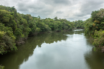 Beautiful view of Acara river with trees, rain and storm clouds in the Amazon rainforest, Concept of environment, global warming, climate change, ecology, biodiversity, conservation and travel.