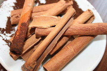 cinnamon sticks and powder on white background