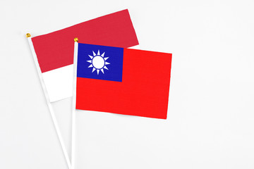 Taiwan and Monaco stick flags on white background. High quality fabric, miniature national flag. Peaceful global concept.White floor for copy space.