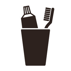 Toothpaste and toothbrush in cup