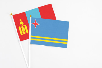 Aruba and Mongolia stick flags on white background. High quality fabric, miniature national flag. Peaceful global concept.White floor for copy space.