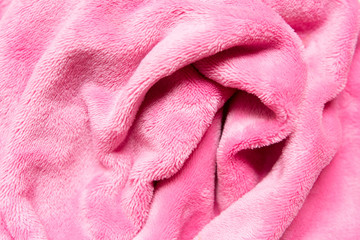 Textile plush background. Soft cozy fabric pattern in pink.