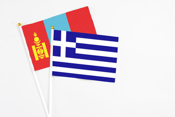 Greece and Mongolia stick flags on white background. High quality fabric, miniature national flag. Peaceful global concept.White floor for copy space.