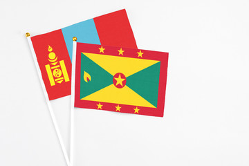 Grenada and Mongolia stick flags on white background. High quality fabric, miniature national flag. Peaceful global concept.White floor for copy space.
