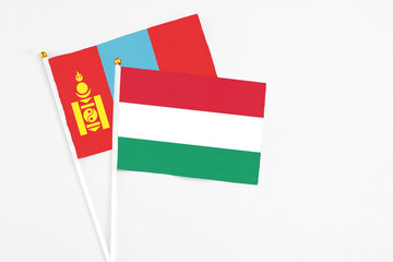 Hungary and Mongolia stick flags on white background. High quality fabric, miniature national flag. Peaceful global concept.White floor for copy space.