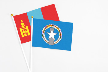 Northern Mariana Islands and Mongolia stick flags on white background. High quality fabric, miniature national flag. Peaceful global concept.White floor for copy space.