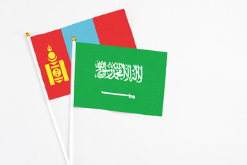 Saudi Arabia and Mongolia stick flags on white background. High quality fabric, miniature national flag. Peaceful global concept.White floor for copy space.