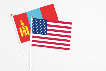 United States and Mongolia stick flags on white background. High quality fabric, miniature national flag. Peaceful global concept.White floor for copy space.