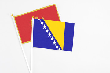 Bosnia Herzegovina and Montenegro stick flags on white background. High quality fabric, miniature...