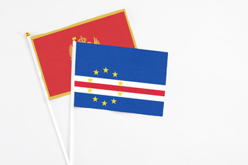 Cape Verde and Montenegro stick flags on white background. High quality fabric, miniature national flag. Peaceful global concept.White floor for copy space.
