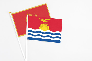 Kiribati and Montenegro stick flags on white background. High quality fabric, miniature national flag. Peaceful global concept.White floor for copy space.