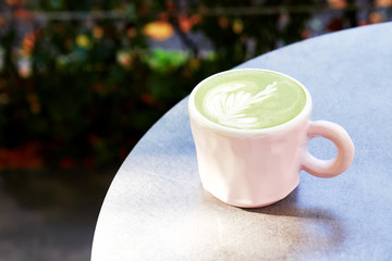 Ceramic cup of matcha latte on grey background