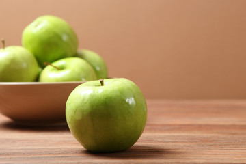 juicy green apples on a wooden table.