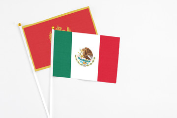 Mexico and Montenegro stick flags on white background. High quality fabric, miniature national flag. Peaceful global concept.White floor for copy space.