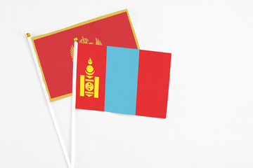 Mongolia and Montenegro stick flags on white background. High quality fabric, miniature national flag. Peaceful global concept.White floor for copy space.