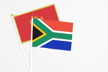 South Africa and Montenegro stick flags on white background. High quality fabric, miniature national flag. Peaceful global concept.White floor for copy space.