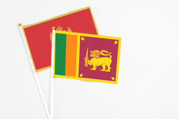 Sri Lanka and Montenegro stick flags on white background. High quality fabric, miniature national flag. Peaceful global concept.White floor for copy space.
