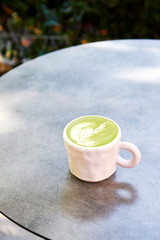 Obraz na płótnie Canvas Ceramic cup of matcha latte on grey background
