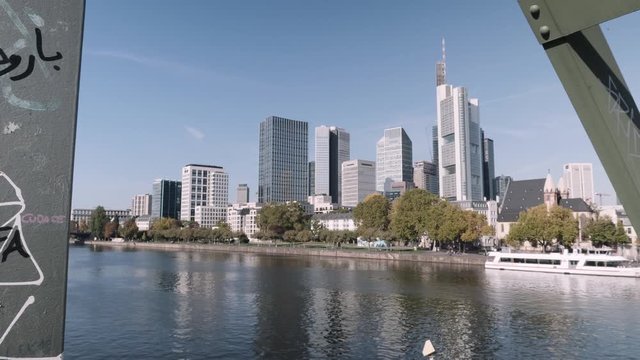 Cityscape view from eiserner Steg Bridge and main river with Skyline of Frankfurt in background during daytime, Hessen, Germany