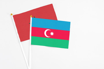 Azerbaijan and Morocco stick flags on white background. High quality fabric, miniature national flag. Peaceful global concept.White floor for copy space.