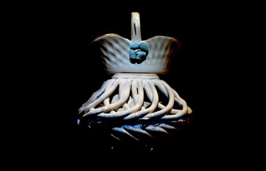 Close up ceramic figure and small basket on top