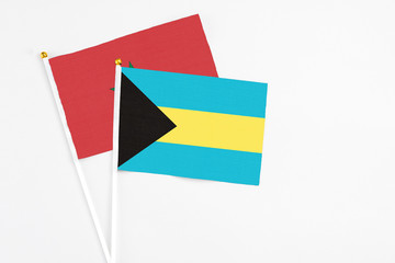 Bahamas and Morocco stick flags on white background. High quality fabric, miniature national flag. Peaceful global concept.White floor for copy space.