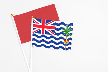 Fototapeta premium British Indian Ocean Territory and Morocco stick flags on white background. High quality fabric, miniature national flag. Peaceful global concept.White floor for copy space.