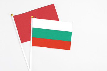 Bulgaria and Morocco stick flags on white background. High quality fabric, miniature national flag. Peaceful global concept.White floor for copy space.