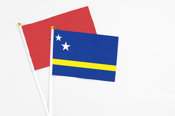Curacao and Morocco stick flags on white background. High quality fabric, miniature national flag. Peaceful global concept.White floor for copy space.