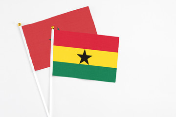 Ghana and Morocco stick flags on white background. High quality fabric, miniature national flag. Peaceful global concept.White floor for copy space.