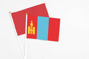 Mongolia and Morocco stick flags on white background. High quality fabric, miniature national flag. Peaceful global concept.White floor for copy space.