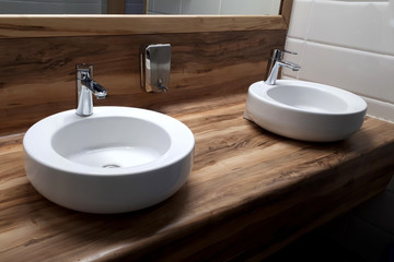 bathroom. white plumbing on a wooden panel