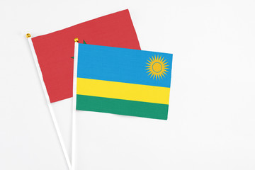Rwanda and Morocco stick flags on white background. High quality fabric, miniature national flag. Peaceful global concept.White floor for copy space.