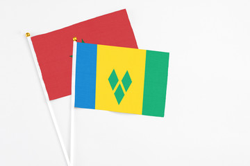 Saint Vincent And The Grenadines and Morocco stick flags on white background. High quality fabric,...