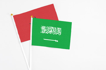 Saudi Arabia and Morocco stick flags on white background. High quality fabric, miniature national flag. Peaceful global concept.White floor for copy space.