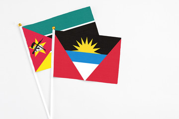 Antigua and Barbuda and Mozambique stick flags on white background. High quality fabric, miniature...