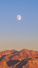 Vertical Moon at sunset over Provo canyon and Utah Lake