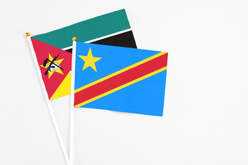 Congo and Mozambique stick flags on white background. High quality fabric, miniature national flag. Peaceful global concept.White floor for copy space.